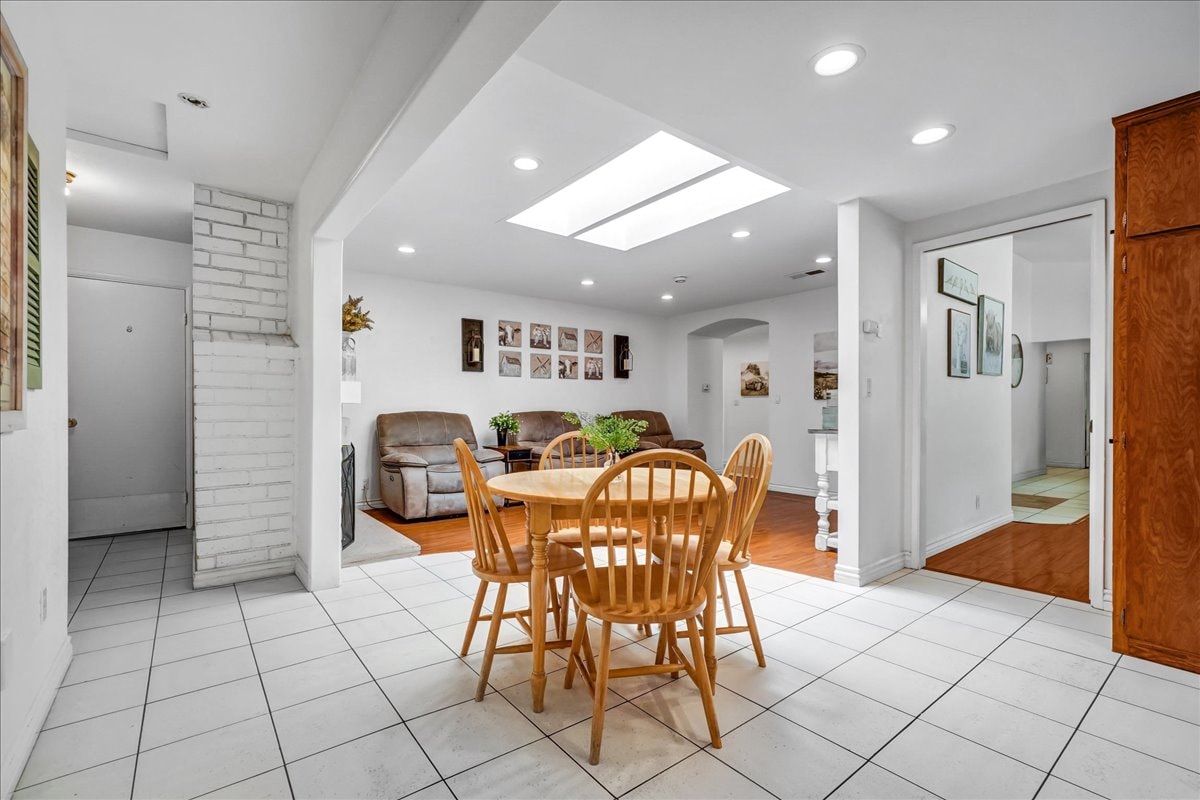 Open dining and living room with skylight at Blessings Senior Care East Orange View, 2431 E. Orangeview Ln Orange CA